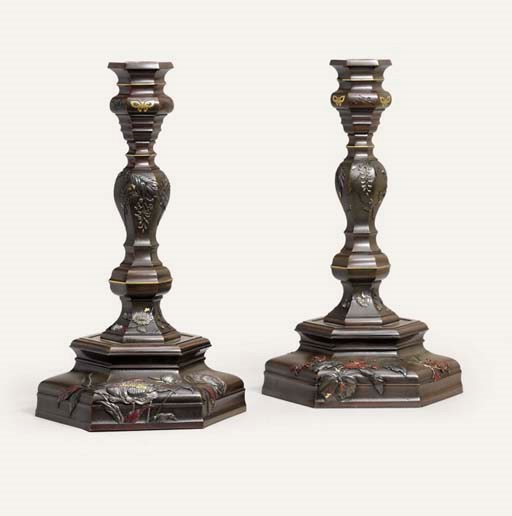 A PAIR OF BRONZE CANDLESTICKS