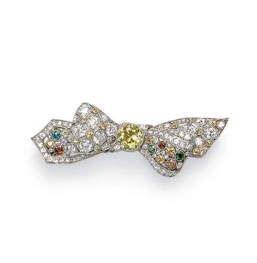 A COLORED DIAMOND BOW BROOCH