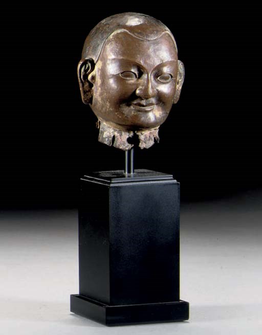 A Tibetan fragmentary bronze Lama head, 18th Century