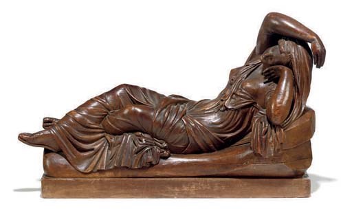 A CONTINENTAL CARVED LIMEWOOD FIGURE OF CLEOPATRA