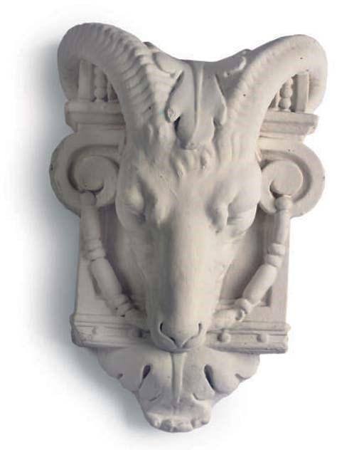 A PAINTED PLASTER RAM'S HEAD WALL MASK