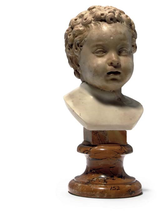 A CARVED MARBLE HEAD OF A PUTTO
