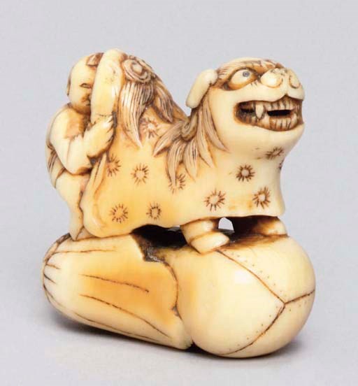 A Japanese ivory netsuke of a Shishimai mask and cloak, 18th Century