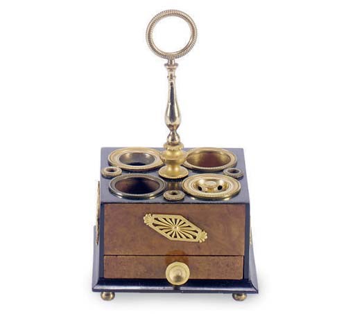 A FRENCH RESTAURATION GILT-BRONZE MOUNTED AMBOYNA ENCRIER,