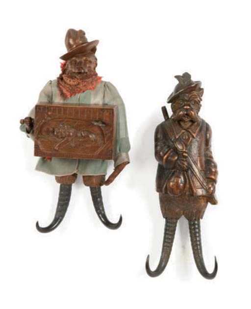 TWO BLACK FOREST CARVED FRUITWOOD AND HORN MUSICAL COAT HOOKS,
