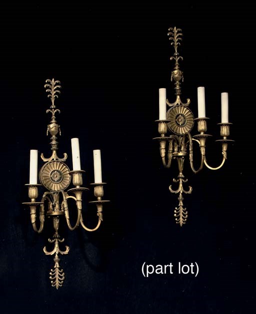 A PAIR OF ORMOLU AND PATINATED BRONZE THREE-LIGHT WALL-APPLIQUES