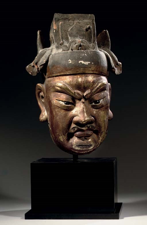 A Chinese polychrome and gilt gesso wood head of a warrior