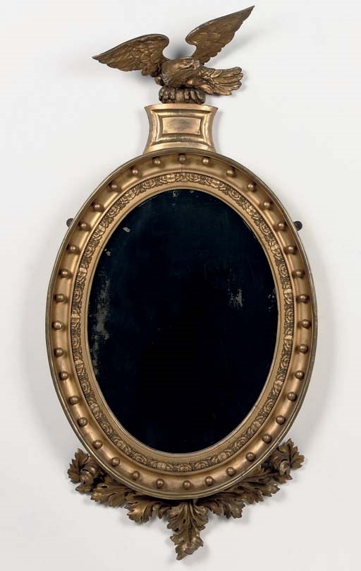 A REGENCY GILTWOOD OVAL MIRROR