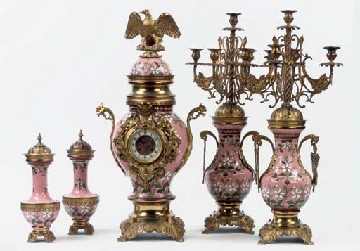 A FIVE PIECE GILT BRASS MOUNTED CHAMPLEVE ENAMEL CLOCK GARNITURE
