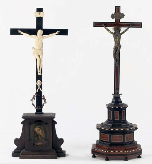 A GERMAN CARVED IVORY AND EBONISED CRUCIFIX AND A FLEMISH GILT VARNISHED SILVER, BONE EBONISED AND ROSEWOOD CRUCIFIX