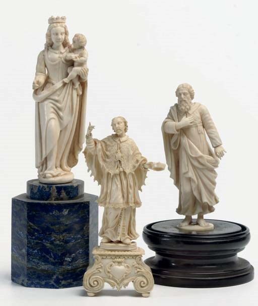 A CARVED IVORY FIGURE OF A MALE SAINT, PROBABLY SAINT PETER OR PAUL