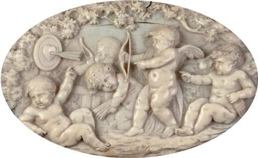 AN OVAL CARVED IVORY RELIEF DEPICTING FROLICKING PUTTI