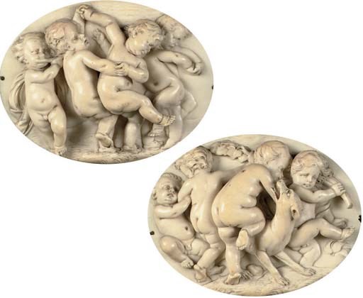 A PAIR OF OVAL CARVED IVORY RELIEFS DEPICTING FROLICKING PUTTI