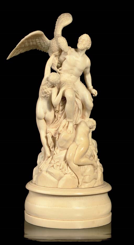 A CARVED IVORY GROUP OF PROMETHEUS AND THE EAGLE