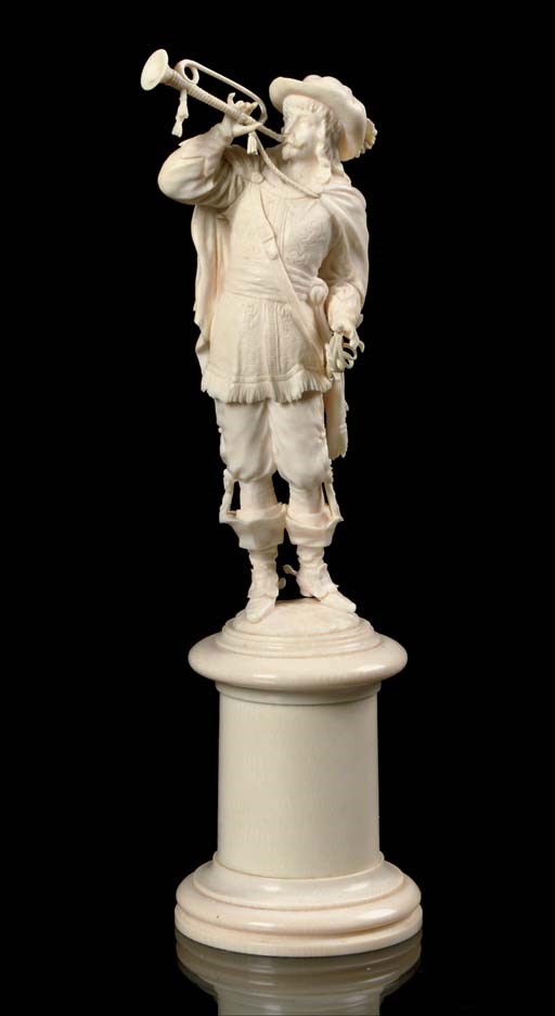 A CARVED IVORY FIGURE OF A BUGLER