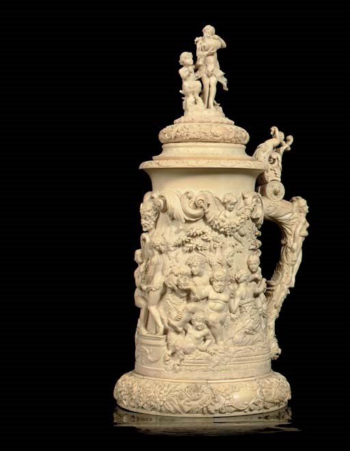 A LARGE CARVED IVORY TANKARD