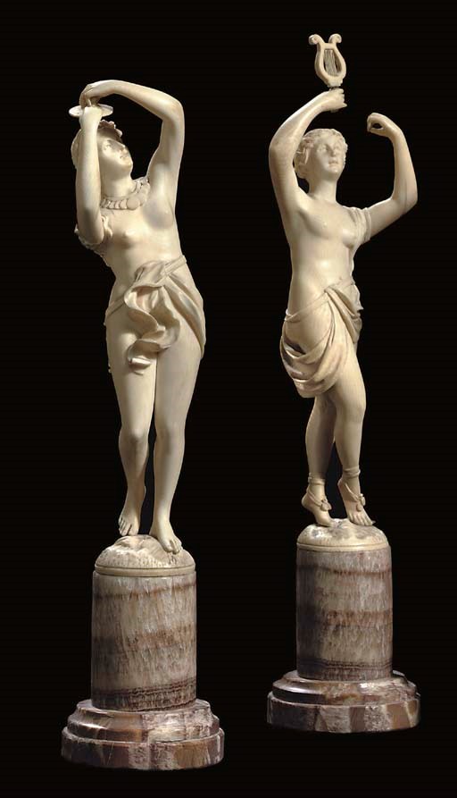 A PAIR OF GERMAN CARVED IVORY FIGURES OF MUSIC-MAKING DANCING NYMPHS