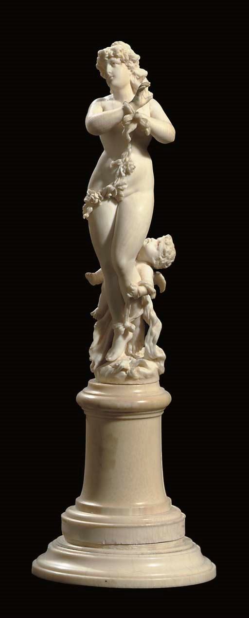 A GERMAN CARVED IVORY GROUP OF VENUS AND CUPID