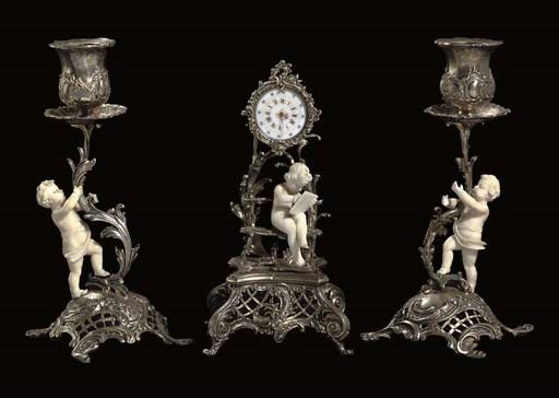 A FRENCH SILVER AND CARVED IVORY MINIATURE THREE-PIECE GARNITURE