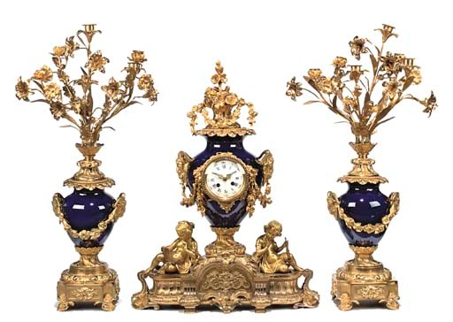 A FRENCH ORMOLU AND SEVRES STYLE COBALT-BLUE-GROUND PORCELAIN THREE-PIECE GARNITURE