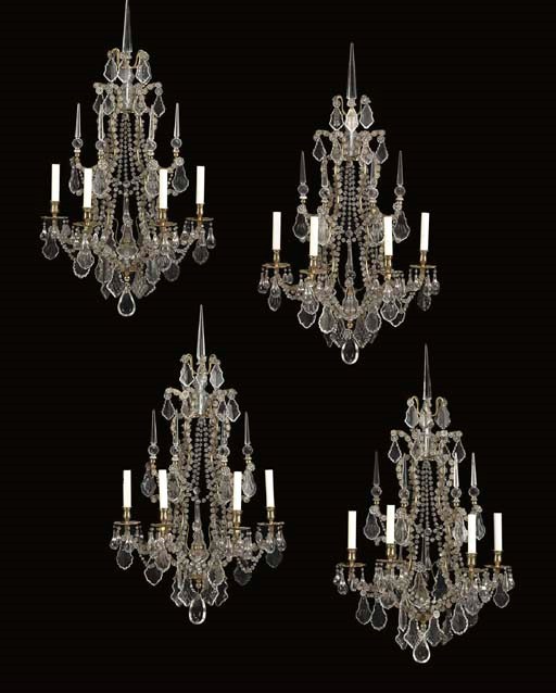 A SET OF FOUR FRENCH GILT-METAL AND CUT GLASS FOUR-LIGHT GIRANDOLES