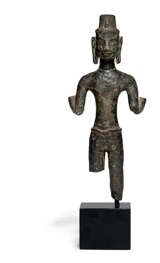 A rare bronze figure of a four-armed deity