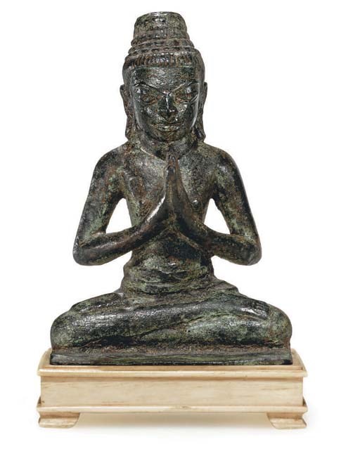 A bronze seated figure in adoration