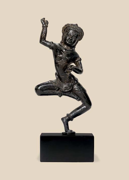 A bronze figure of a dancing dakini