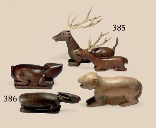 Two wooden figures of deer
