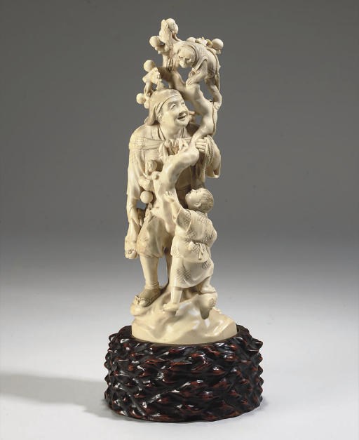 A Large Japanese ivory okimono of a man and monkey group, 19th Century
