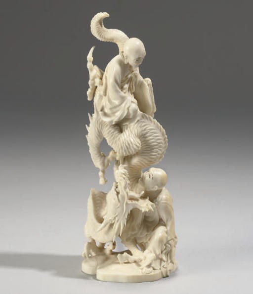 A Japanese ivory monks and dragon group, mid 20th century