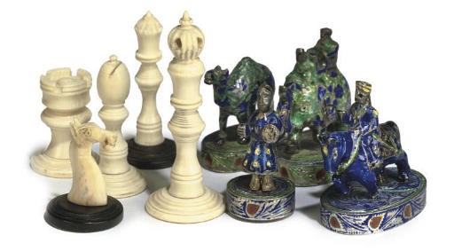AN INDIAN ENAMELLED AND SILVER COLOURED METAL FIGURAL CHESS SET