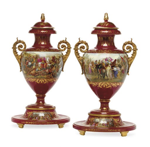 A PAIR OF ORMOLU-MOUNTED VIENNA STYLE BURGUNDY-GROUND VASES, COVERS AND CIRCULAR STANDS