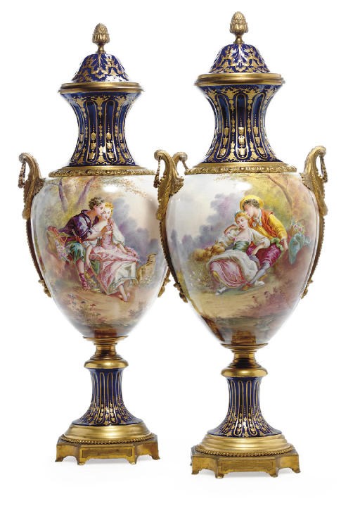 A PAIR OF ORMOLU-MOUNTED SÈVRES STYLE COBALT-BLUE GROUND BALUSTER VASES AND COVERS