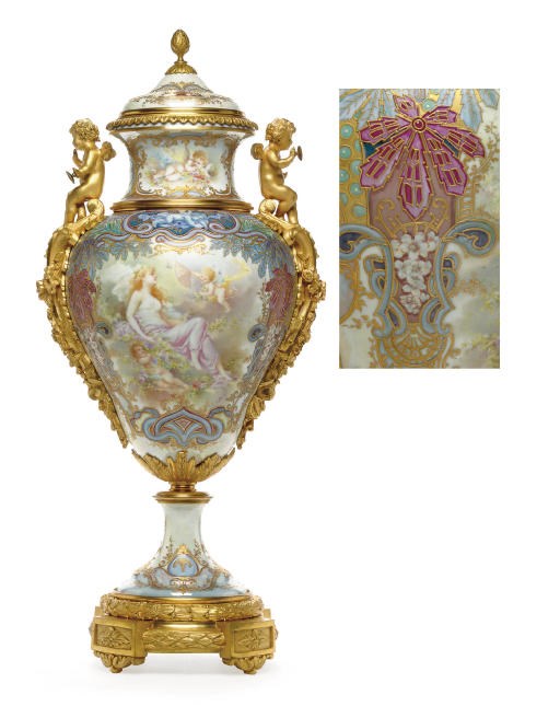 AN ORMOLU-MOUNTED SÈVRES STYLE IRIDESCENT PALE-BLUE GROUND VASE AND COVER
