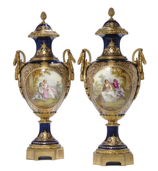 A PAIR OF ORMOLU-MOUNTED SÈVRES STYLE COBALT-BLUE GROUND VASES AND COVERS