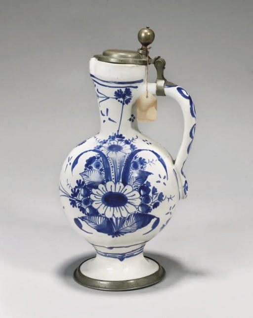A GERMAN FAYENCE BLUE AND WHITE PEWTER-MOUNTED CYLINDRICAL TANKARD (WALZENKRUG) AND A JUG (ENGHALSKRUG) SIMILAR