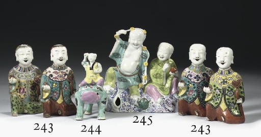 A famille rose figure of a boy seated on a toad