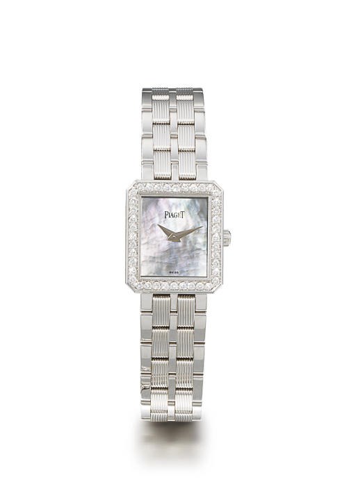 PIAGET. A LADY'S 18K WHITE GOLD AND DIAMOND-SET WRISTWATCH WITH BRACELET AND MOTHER-OF-PEARL DIAL