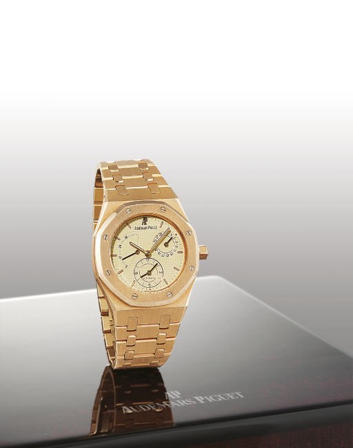 AUDEMARS PIGUET. AN 18K PINK GOLD AUTOMATIC TWO TIME ZONE WRISTWATCH WITH BRACELET, DATE AND POWER RESERVE INDICATION