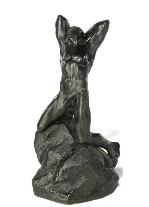 A FRENCH BRONZE FIGURE OF A MAN KNEELING ON A ROCK
