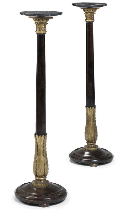 A PAIR OF ITALIAN PARCEL-GILT WALNUT TORCHERES