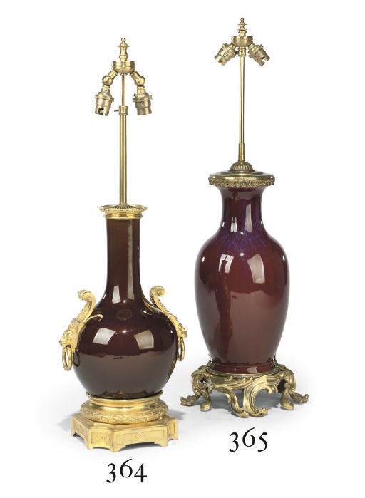 A GILT-BRONZE MOUNTED RED FLAMBÉ GLAZED PORCELAIN TABLE LAMP