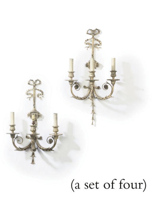A SET OF FOUR GILT-BRONZE THREE-LIGHT WALL APPIQUES