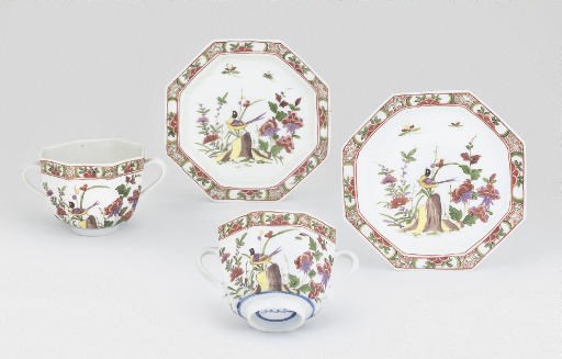 A PAIR OF MEISSEN TWO-HANDLED OCTAGONAL CUPS AND SAUCERS