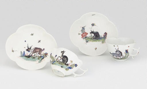 A PAIR OF MEISSEN QUATREFOIL FABELTIERE TEACUPS AND SAUCERS