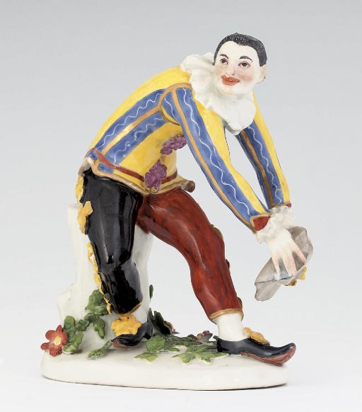 A MEISSEN FIGURE OF THE 'GREETING HARLEQUIN'