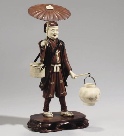 A Japanese wood and ivory okimono of a salesman, 20th Century
