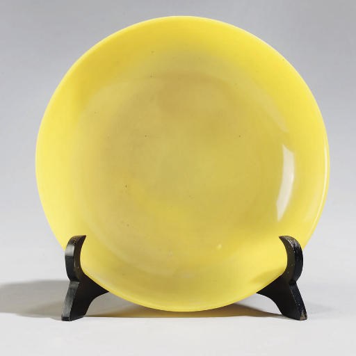 A Beijing yellow glass saucer-shaped dish, Qianlong four-character mark and probably of the period