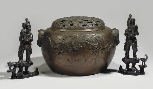 A pair of Chinese bronze models of boys holding vases, 17th century